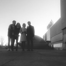 People standing in front of skyscraper