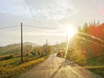 Road amidst plants against sky