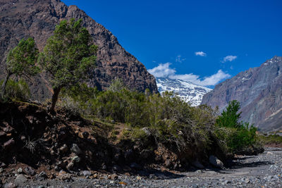 Scenic view of mountains against blue sky