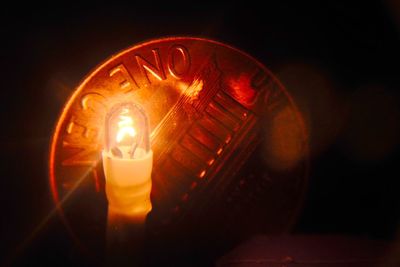 Close-up of illuminated lamp at night