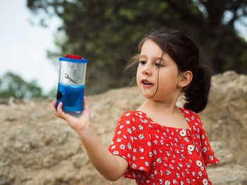 Girl looking away while standing on glass
