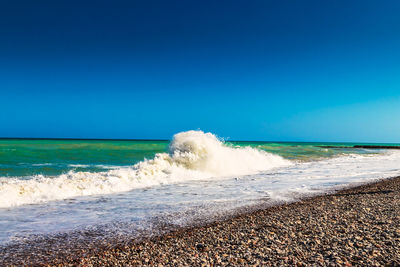 Scenic view of sea against clear blue sky