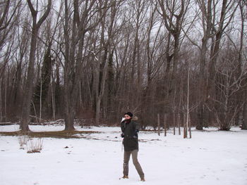 Full length of man standing on snow covered field