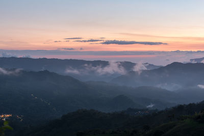 Scenic view of mountains against sky at sunset