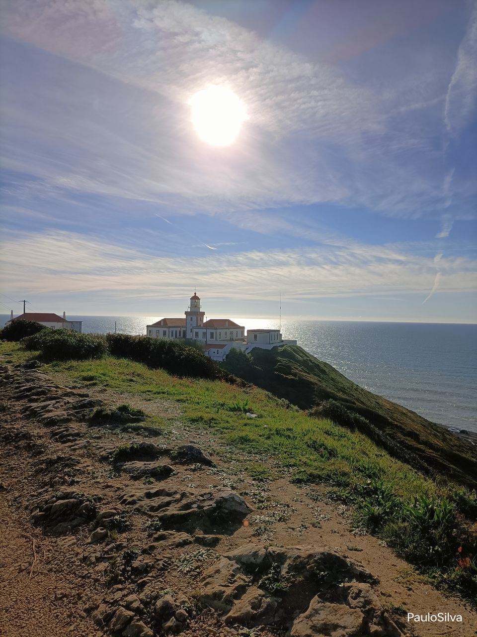 sky, coast, sea, water, horizon, architecture, tower, ocean, land, built structure, nature, beach, shore, lighthouse, building exterior, cloud, scenics - nature, building, cliff, beauty in nature, hill, rock, horizon over water, travel destinations, landscape, history, sunlight, travel, tranquility, the past, no people, tourism, tranquil scene, outdoors, terrain, coastline, guidance, environment, sun, bay, body of water, day, religion, wave, sunset, plant, idyllic