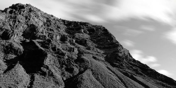 Low angle view of rock formation against sky