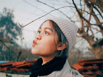 Portrait of young woman looking away in winter