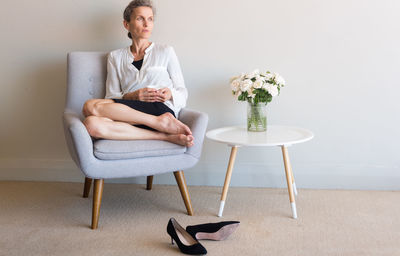 Woman sitting on chair at home