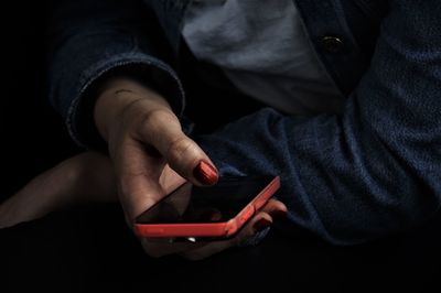 Midsection of woman using mobile phone