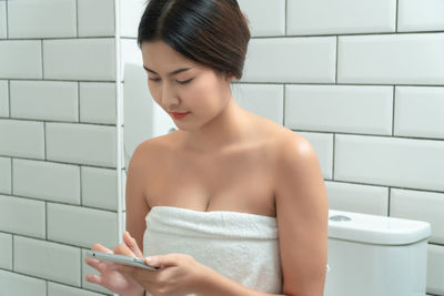 Young woman looking at camera at home