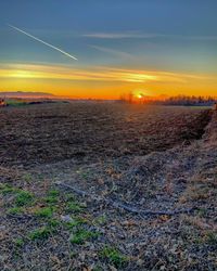 Scenic view of field against sky during sunset