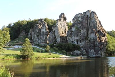 Scenic view of rock formation in lake against sky