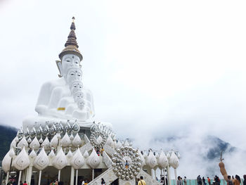 Low angle view of sculptures on building against sky