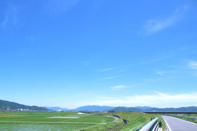 Scenic view of landscape against blue sky