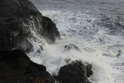 Waves splashing on rocks at shore