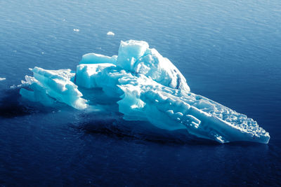 Aerial view of iceberg floating on sea