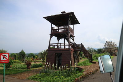Low angle view of lifeguard tower by building against sky