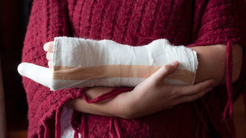 Midsection of woman with fractured hand