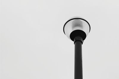 Low angle view of street light against sky