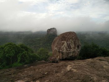 Scenic view of rocks on land against sky