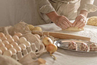 Midsection of man preparing food on table