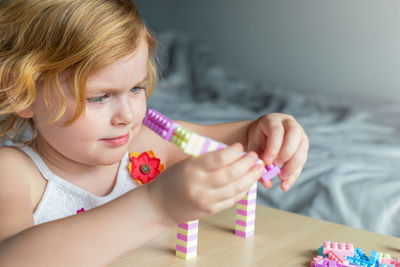 Portrait of girl holding table