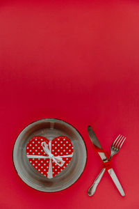 High angle view of heart shape on red table