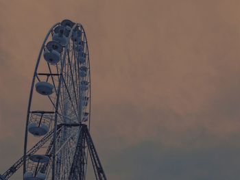 Low angle view of ferris wheel against sky