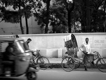 Man with pedicab on street in city