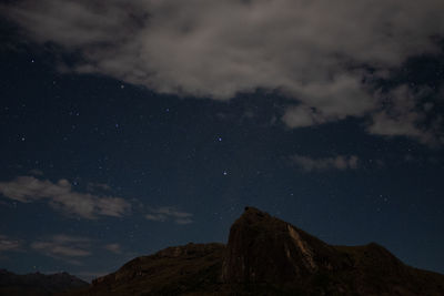 Low angle view of mountain against sky at night