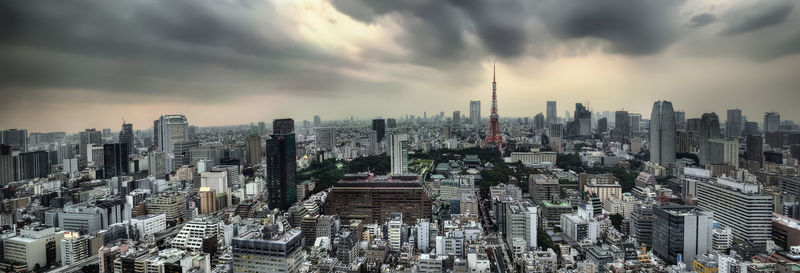 Panoramic view of modern buildings against cloudy sky