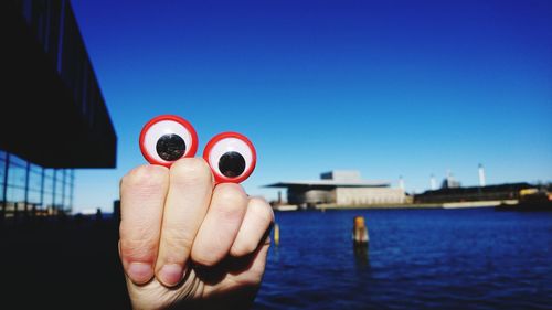 Close-up of googly eyes on hand