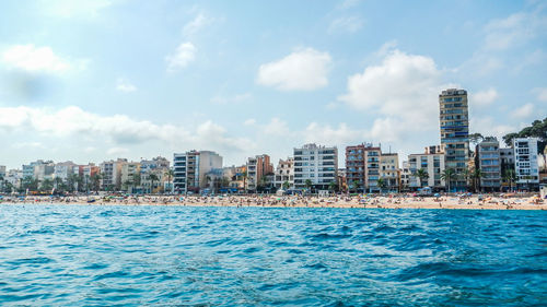 Scenic view of sea and buildings against sky