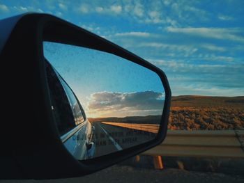 Reflection of sky on side-view mirror