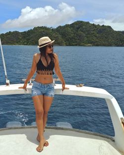 Full length of woman sitting on boat in sea