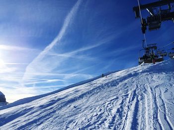 Scenic view of snowcapped mountains against blue sky