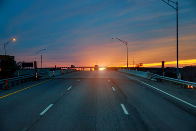 Cars on road at sunset