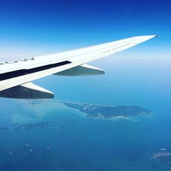 Aerial view of airplane wing against clear blue sky