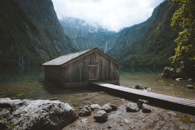 Log cabin in lake against mountain