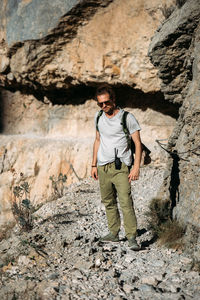 Brutal traveler man hiking in the mountains with walkie talkie outdoors 