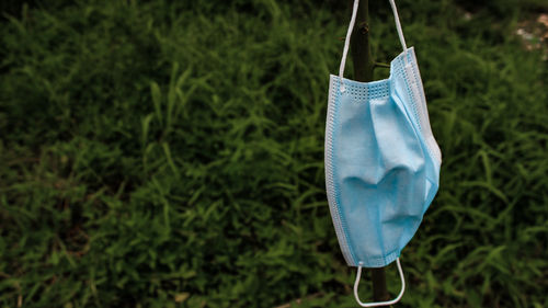 Close-up of clothespins hanging on clothesline in field