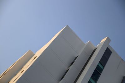 Low angle view of modern building against clear blue sky