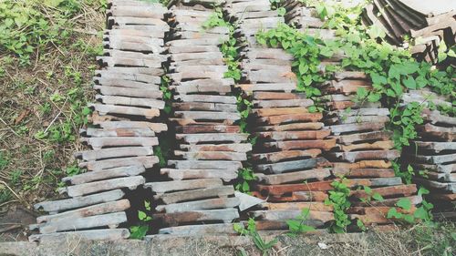 High angle view of roof tiles arranged on field