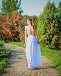 Rear view of woman walking in park