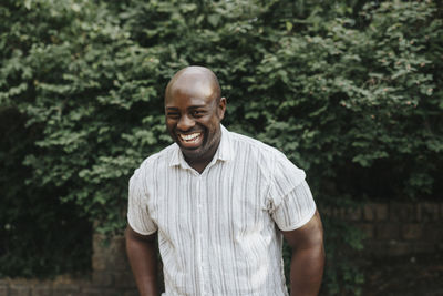 Portrait of laughing man standing outdoors