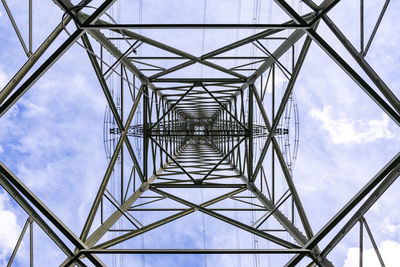 Different patterns and lines of high voltage steel pole construction directly from below