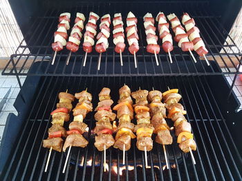 High angle view of shish kebabs cooking on barbecue grill