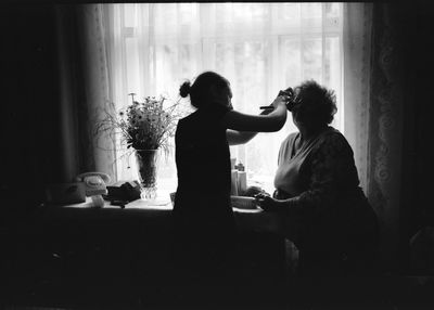 Woman applying make-up on mother