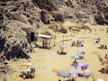 High angle view of people relaxing on beach