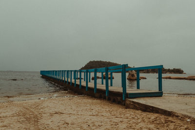 Lifeguard hut on beach against clear sky